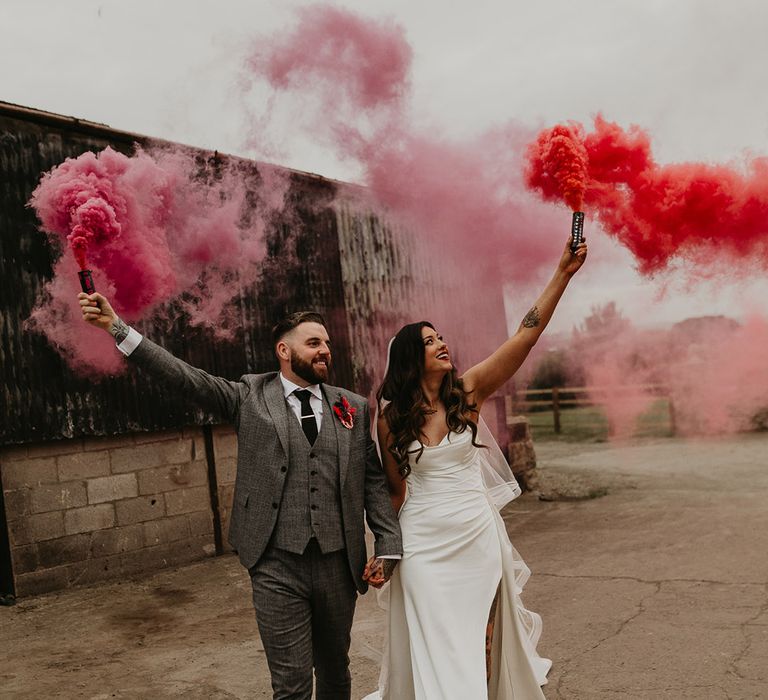 bride-and-groom-waving-pink-and-red-smoke-bombs