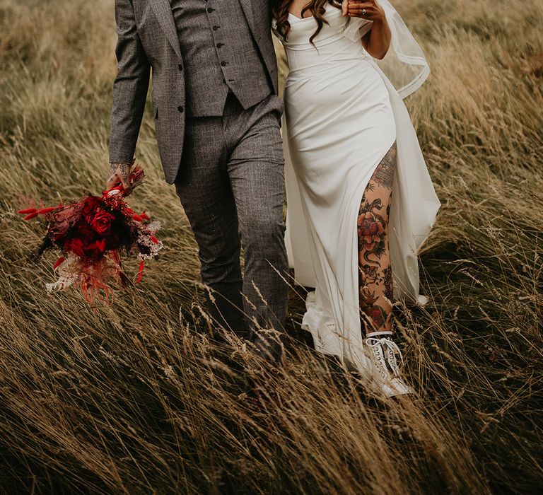 groom-in-grey-wedding-suit-with-bride-in-front-slit-wedding-dress