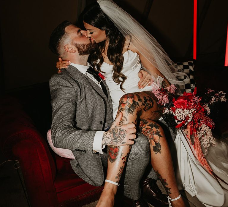 tattooed-bride-kisses-groom-at-wedding