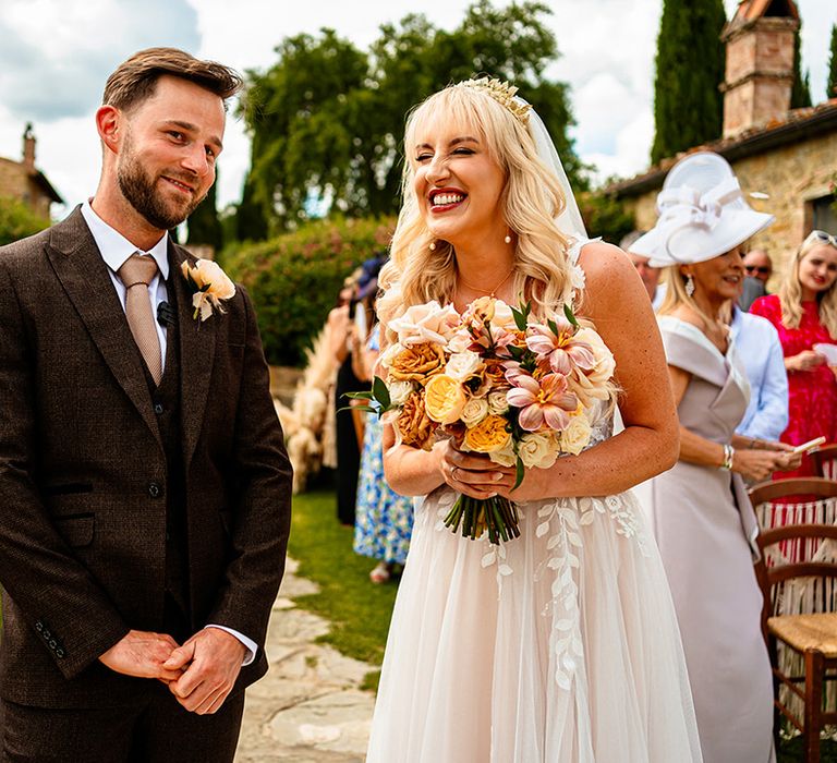 bride-and-groom-smiling-at-outdoor-wedding-ceremony