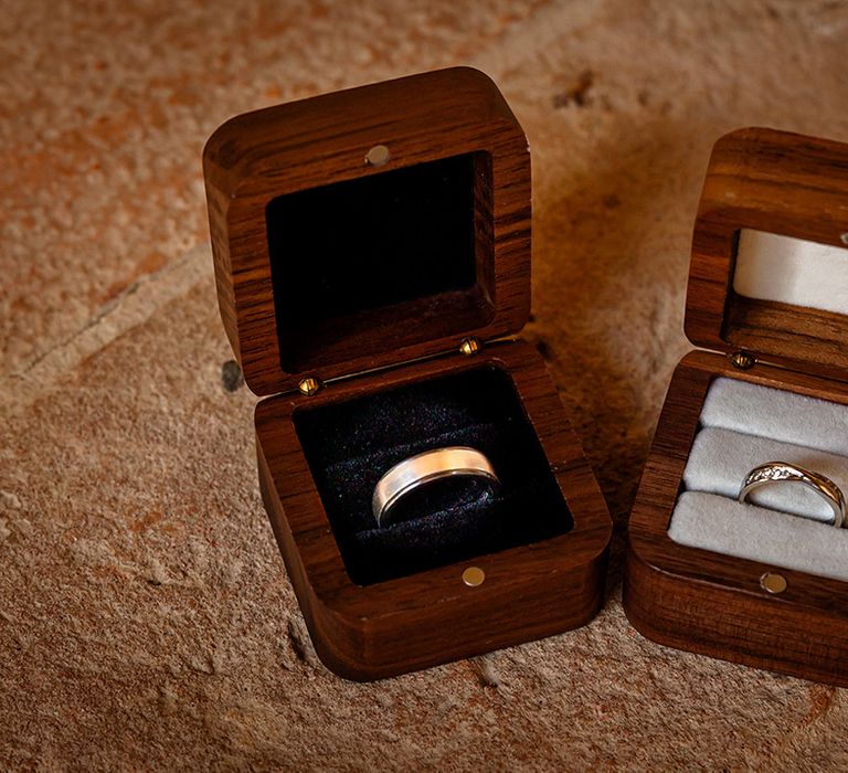 bride-and-grooms-wedding-rings-in-wooden-ring-boxes