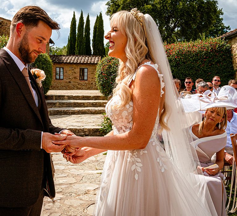 groom-wearing-brown-wedding-suit-with-bride-in-tulle-wedding-dress