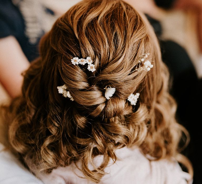 bride-wearing-hair-in-delicate-braided-haistyle-with-flower-hair-accessories