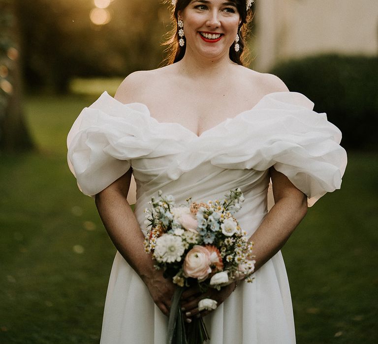 bride-wearing-off-the-shoulder-statement-ruffle-neckline-wedding-dress-with-pearl-headband