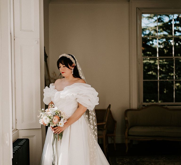 bride-with-floral-wedding-veil-in-wedding-dress-with-statement-ruffle-neckline