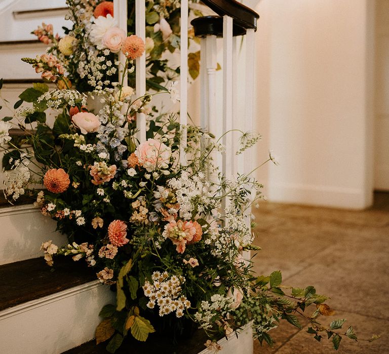 peach-and-white-wedding-staircase-flower-arrangements