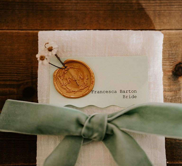 wedding-place-name-with-wax-seal-and-teal-bows