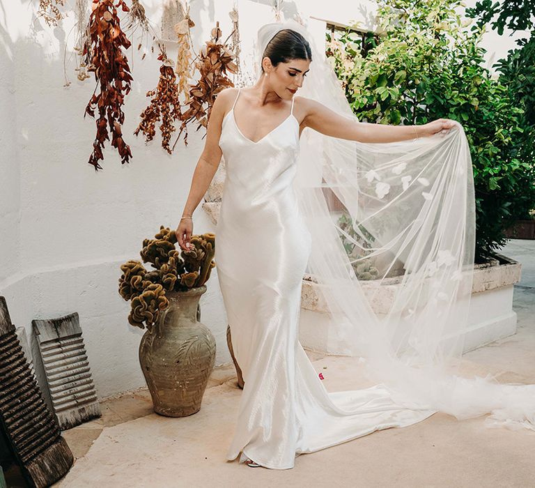 bride-in-satin-wedding-dress-with-embroidered-veil