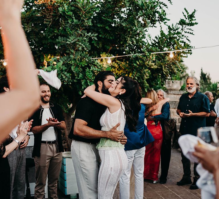 couple-dancing-surrounded-by-guests-at-party