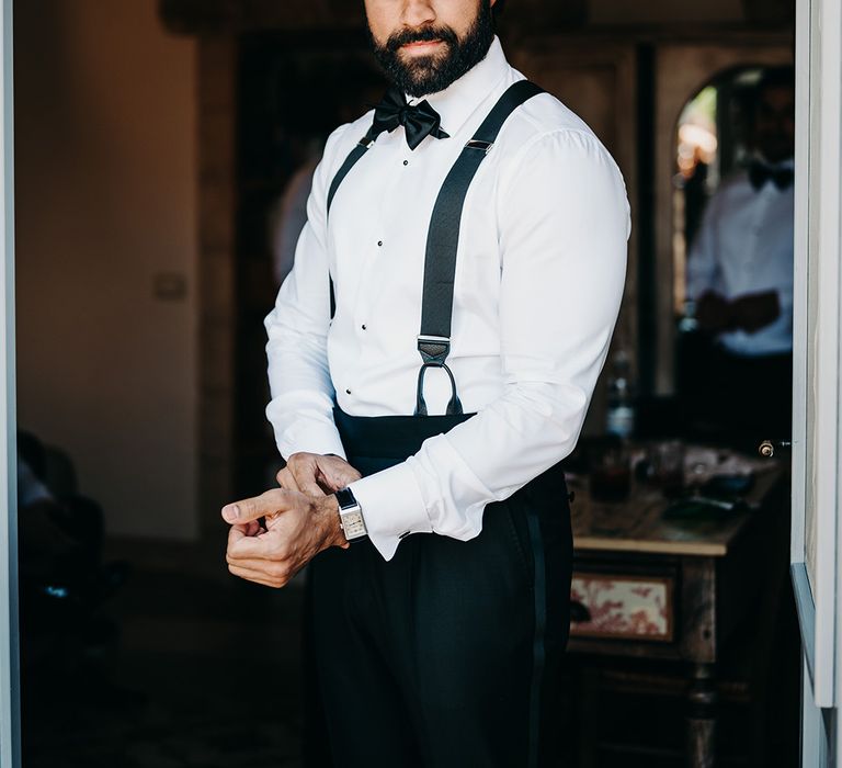 groom-wearing-white-shirt-and-black-bow-tie