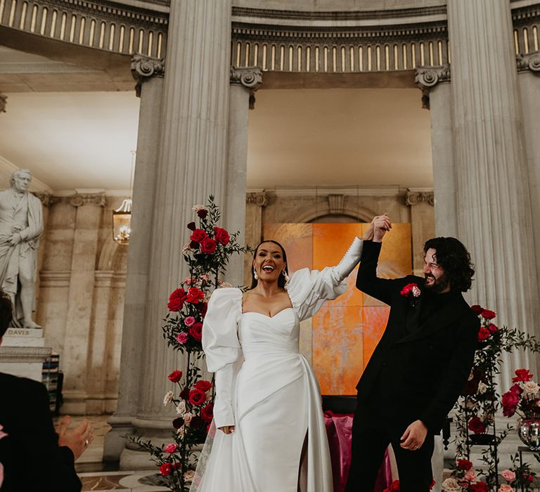 bride-and-groom-face-their-wedding-guests-as-they-are-announced-as-married-couple