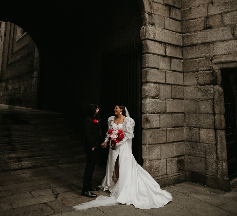 bride-in-princess-wedding-dress-with-groom-in-black-suit