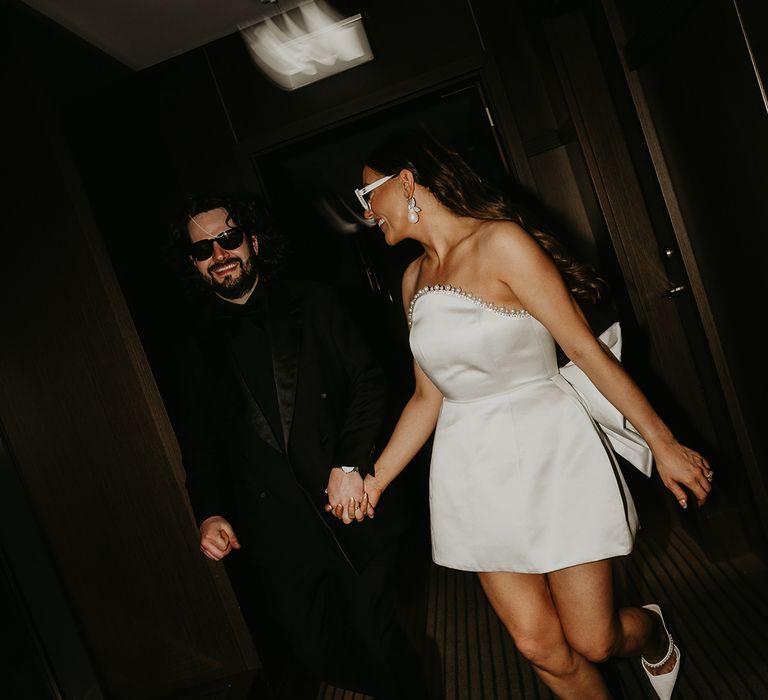 bride-in-short-strapless-wedding-reception-dress-with-bow