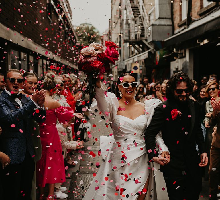 confetti-moment-for-bride-and-groom-as-they-celebrate-with-brass-band