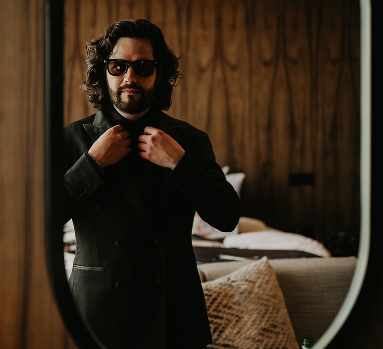 groom-wearing-all-black-wedding-suit-with-sunglasses