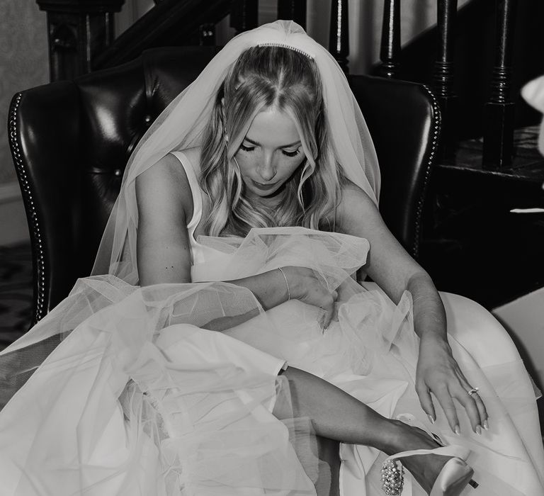 bride-putting-on-wedding-shoes