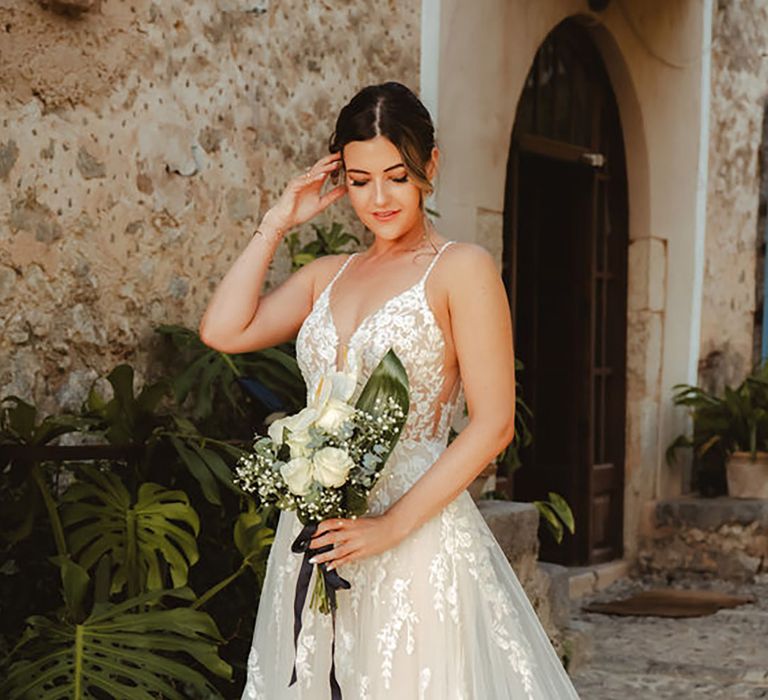 bride wearing lace tulle wedding dress with plunge neckline