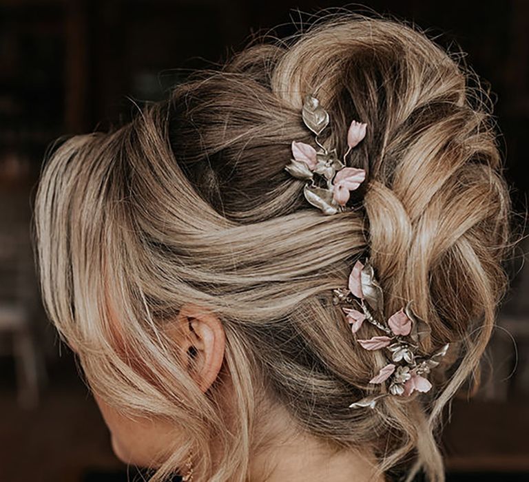 bridal-updo-with-pink-floral-hair-accessory-Ditty-Lens-Photography