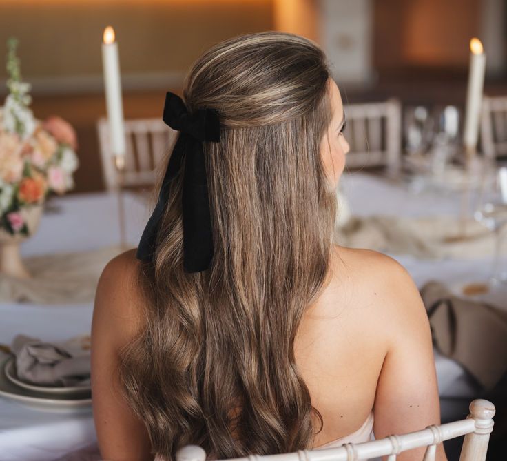 Bride Wearing Half Up Half Down Wedding Hair with Black Hair Bow Accessory