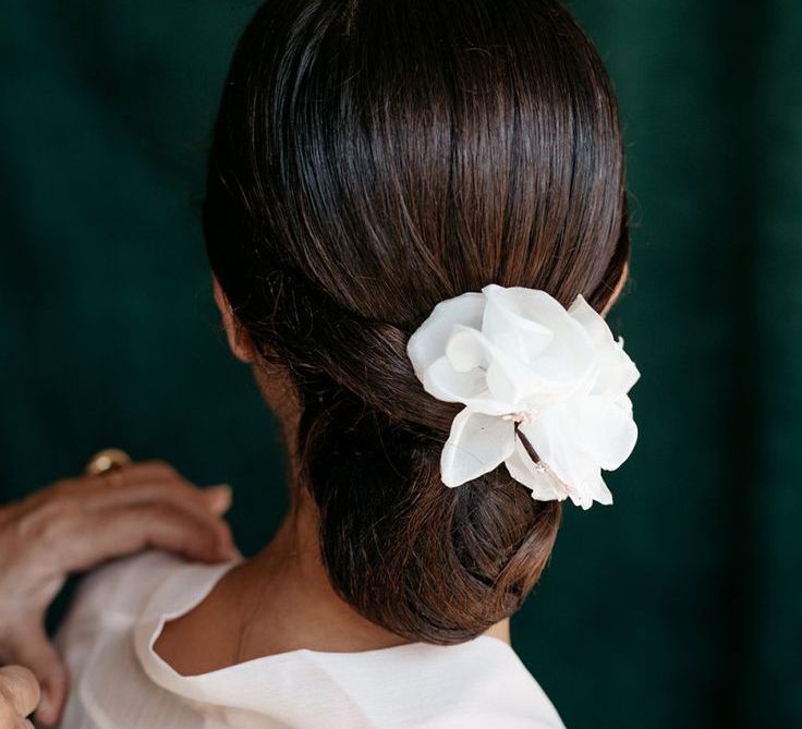 Sleek Wedding Hair With White Flower Hairpiece