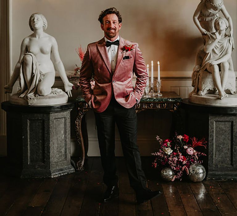 groom wearing colourful pink velvet groom suit