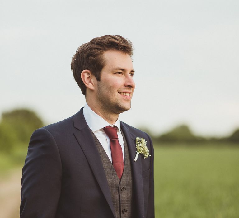 Groom in Navy DKNY Suit from Moss Bros