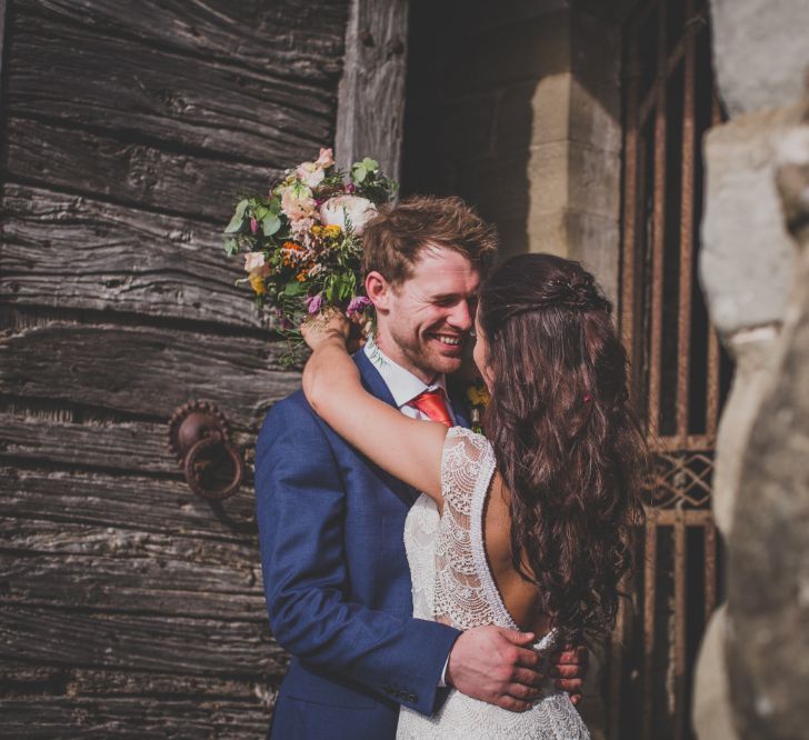 Outdoor Wedding Ceremony in Tuscany With Bright Florals And Rustic Wooden Seating