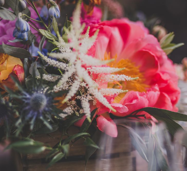 Outdoor Wedding Ceremony in Tuscany With Bright Florals And Rustic Wooden Seating