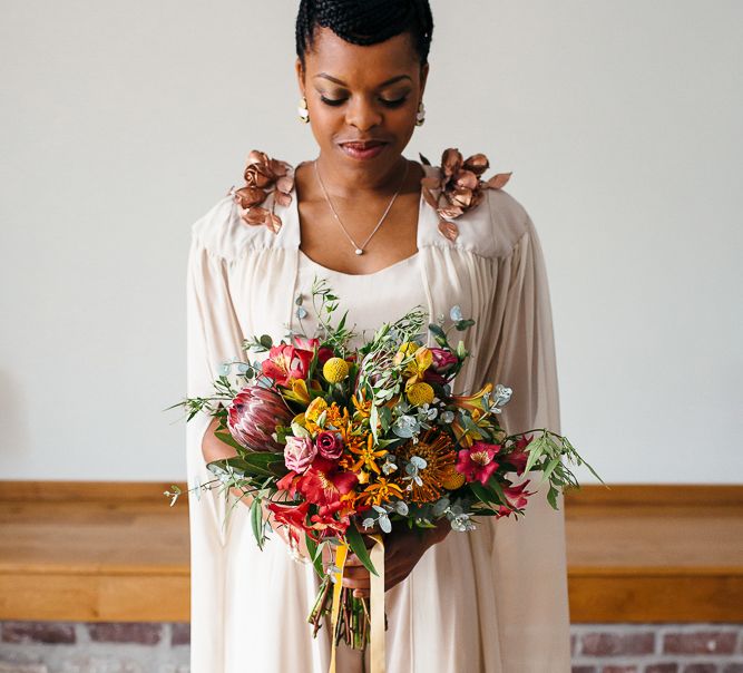 Bright Bouquets with Proteas | Bride in Bespoke Ailsa Monroe Jumpsuit & Cape | Relaxed Industrial Wedding at Ocean Studios, Plymouth | Freckle Photography