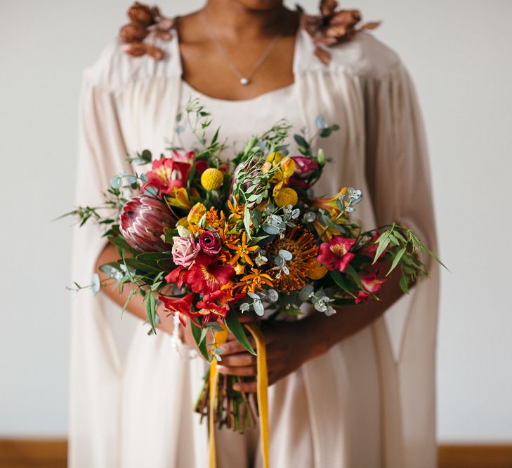 Bright Bouquets with Proteas | Bride in Bespoke Ailsa Monroe Jumpsuit & Cape | Relaxed Industrial Wedding at Ocean Studios, Plymouth | Freckle Photography