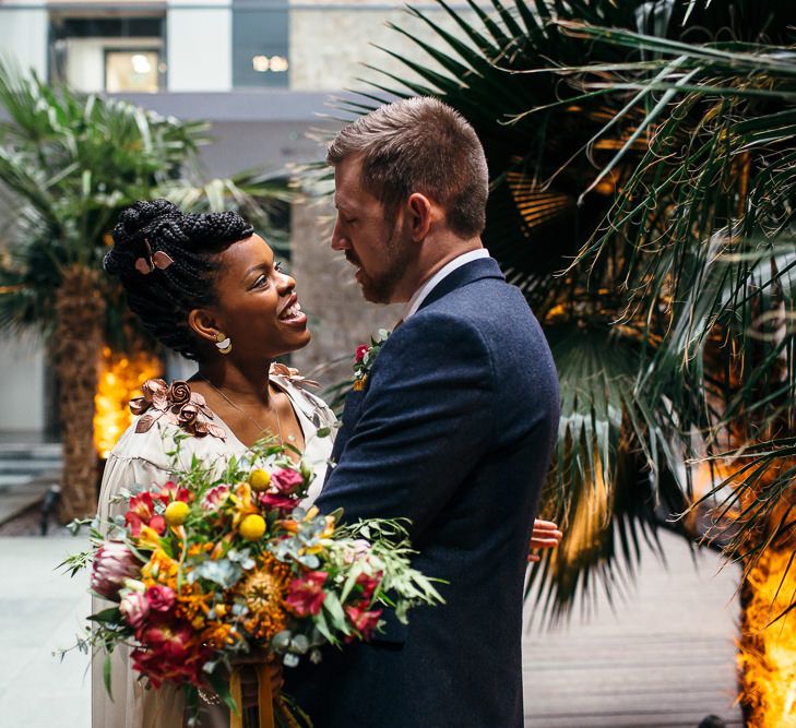 Bride in Bespoke Ailsa Monroe Jumpsuit & Cape | Groom in Next Navy Wool Suit | Relaxed Industrial Wedding at Ocean Studios, Plymouth | Freckle Photography