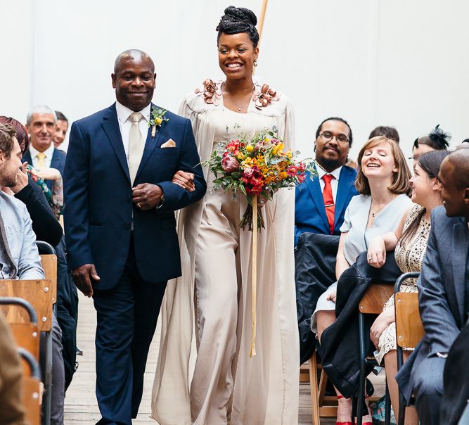 Wedding Ceremony | Bride in Bespoke Ailsa Monroe Jumpsuit & Cape | Father of The Bride in Navy Suit | Relaxed Industrial Wedding at Ocean Studios, Plymouth | Freckle Photography