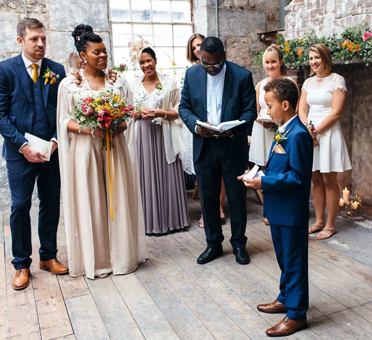 Wedding Ceremony | Bride in Bespoke Ailsa Monroe Jumpsuit & Cape | Groom in Next Navy Wool Suit | Relaxed Industrial Wedding at Ocean Studios, Plymouth | Freckle Photography