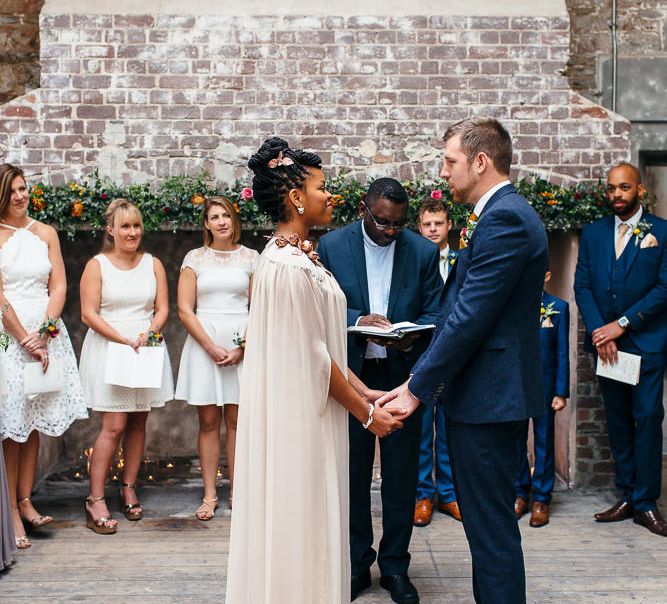 Wedding Ceremony | Bride in Bespoke Ailsa Monroe Jumpsuit & Cape | Groom in Next Navy Wool Suit | Relaxed Industrial Wedding at Ocean Studios, Plymouth | Freckle Photography