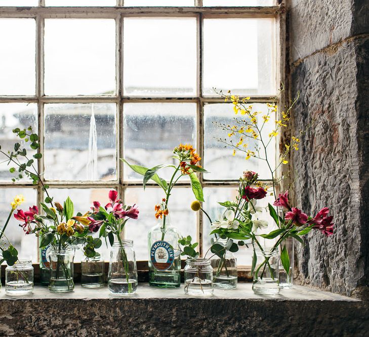 Flower Stems in Bottles | | Relaxed Industrial Wedding at Ocean Studios, Plymouth | Freckle Photography