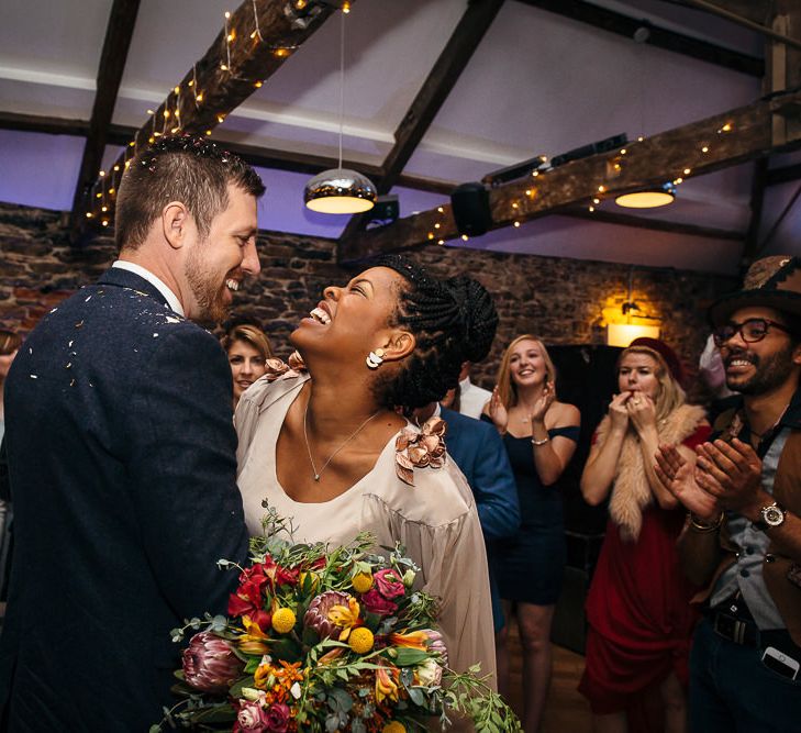 First Dance | Bride in Bespoke Ailsa Monroe Jumpsuit & Cape | Groom in Next Navy Wool Suit | Relaxed Industrial Wedding at Ocean Studios, Plymouth | Freckle Photography