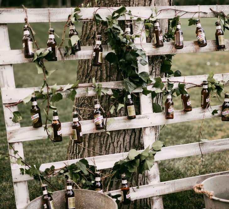 Brown Bottles Hanging on a Rustic Crate Wedding Decor