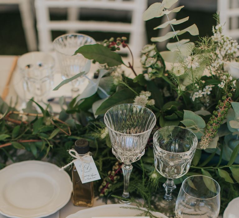 Elegant Place Setting with Gold Flatware & Greenery Table Runner