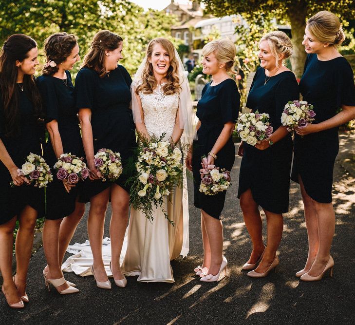 Bride in Lace & Satin Justin Alexander Wedding Dress with Bridesmaids in Navy Dresses | Andy Gaines Photography