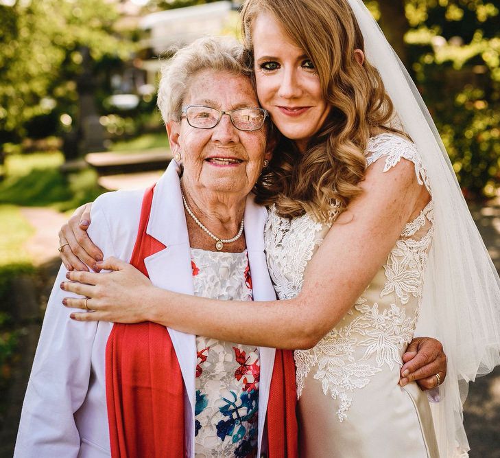 Bride in Lace & Satin Justin Alexander Wedding Dress with Wedding Guest | Andy Gaines Photography