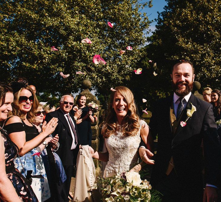 Bride in Lace & Satin Justin Alexander Wedding Dress | Groom in Traditional Morning Suit from Moss Bros | Andy Gaines Photography