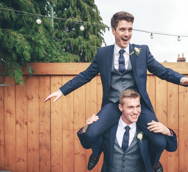 Groomsmen In Navy Suits With Waistcoats