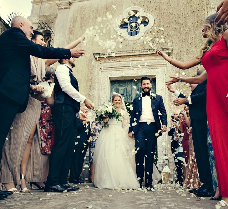 Confetti Moment with Bride in Bespoke Lyn Ashworth by Sarah Barrett Wedding Dress & Groom in Charles Tyrwhitt Black Tie Suit