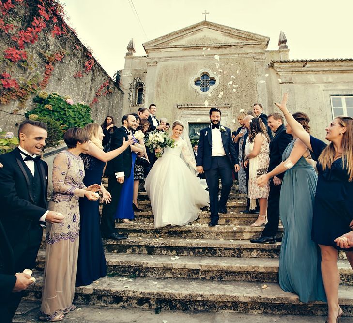 Confetti Moment with Bride in Bespoke Lyn Ashworth by Sarah Barrett Wedding Dress & Groom in Charles Tyrwhitt Black Tie Suit