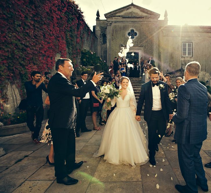 Confetti Moment with Bride in Bespoke Lyn Ashworth by Sarah Barrett Wedding Dress & Groom in Charles Tyrwhitt Black Tie Suit