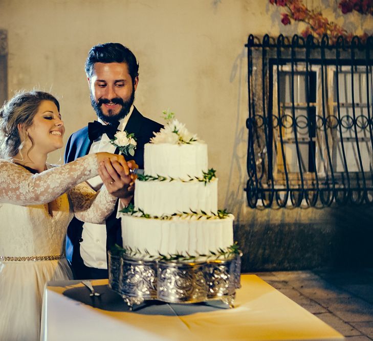 Cutting the Cake with Bride in Bespoke Lyn Ashworth by Sarah Barrett Wedding Dress & Groom in Charles Tyrwhitt Black Tie Suit