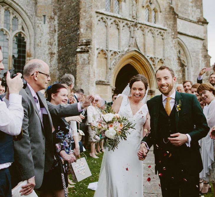 Confetti Moment | Bride in Rose & Delilah Gown | Groom in Donegal Green Wool Three Piece Suit from Beggars Run | David Jenkins Photography | Confetti & Silk Films