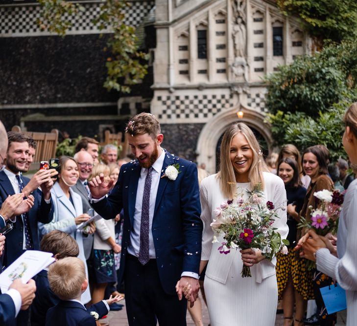 Confetti Exit | Bride in Pleats Please Issey Miyak Dress | Groom in Beggars Run Suit | Chic London Wedding at St Bartholomew the Great Church & St John Bar & Restaurant | Helen Abraham Photography