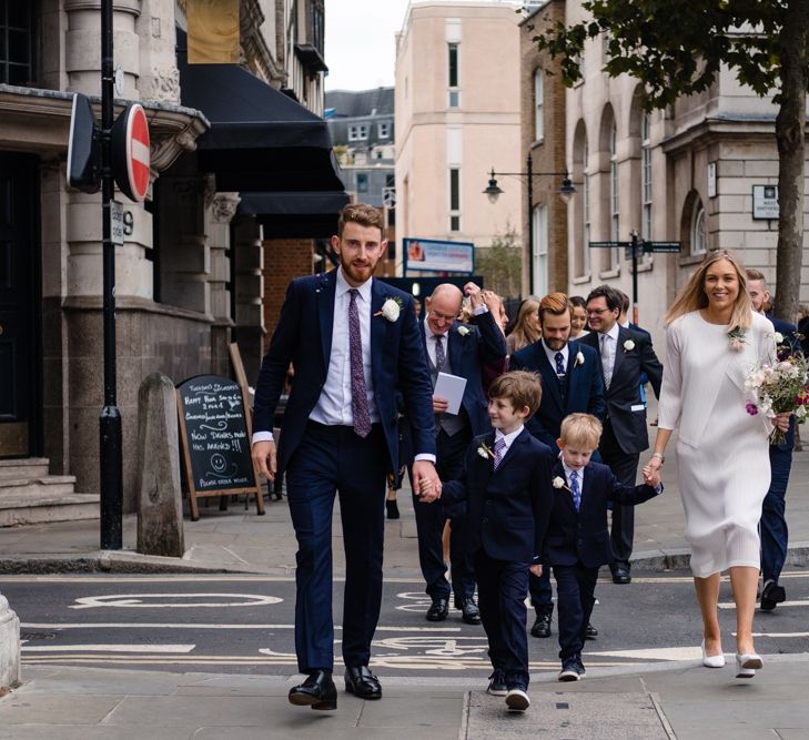 Bride in Pleats Please Issey Miyak Dress | Groom in Beggars Run Suit | Chic London Wedding at St Bartholomew the Great Church & St John Bar & Restaurant | Helen Abraham Photography