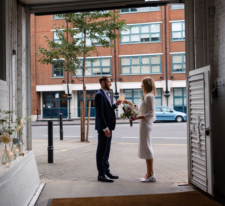 Bride in Pleats Please Issey Miyak Dress | Groom in Beggars Run Suit | Chic London Wedding at St Bartholomew the Great Church & St John Bar & Restaurant | Helen Abraham Photography